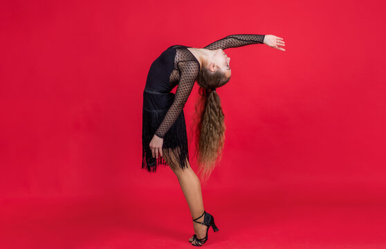 cute child girl in ballroom dress posing while dancing, dancer