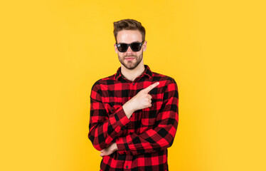 pointing finger. barbershop concept. mens wear. young handsome guy in checkered shirt and glasses. stylish male wear casual clothes. bearded man with bristle on unshaven face. fashion and beauty