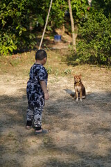 child playing with dog