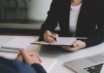 Management members checking candidate's resume after recruitment review