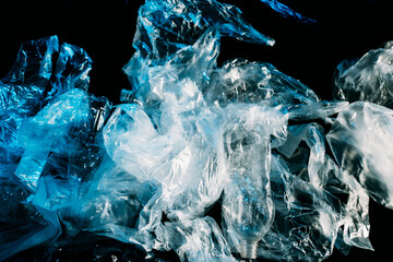 Pollution art. Plastic recycling. Waste contamination. Save nature. Blue creased polyethylene film...