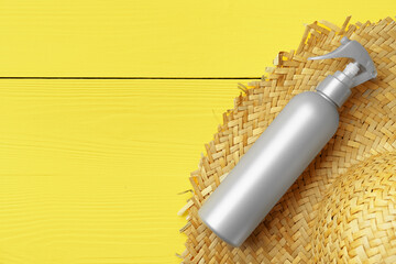 Gray cosmetic bottle on yellow wooden background