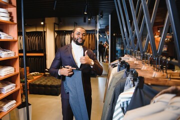 African American man, clothing store, chooses clothes