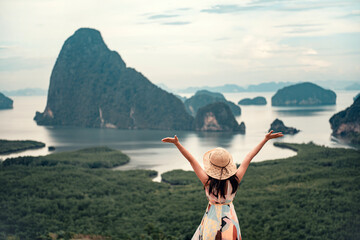 Freedom traveler woman relaxing with raised arms on the top of mountain at Samed nang chee...