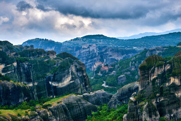 View on pillars of sedimentary rocks in famous Meteora valley at overcast day. Roussanou nunnery and Varlaam monastery, Greece, UNESCO World Heritage