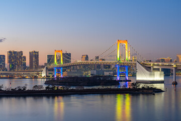 Tokyo skyline at night with view of Rainbow bridge in Japan