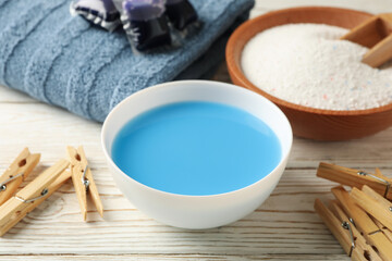 Laundry accessories on white wooden background, close up
