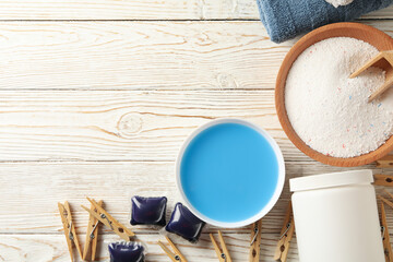 Laundry accessories on white wooden background, top view
