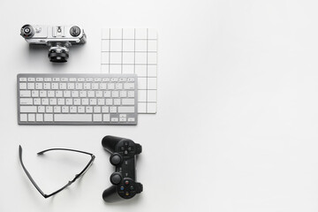 Composition with computer keyboard and different modern devices on white background