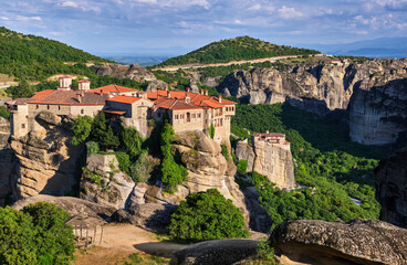 Fototapeta na wymiar Cliff top Varlaam monastery, Meteora, Greece, typical landscape, rocky pillars. Moni Agias Varvaras Roussanou nunnery below. UNESCO World Heritage