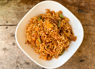 indonesian instant noodle served in white bowl.