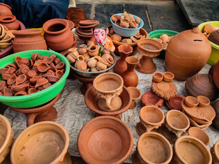 Clay oil lamps, small pots, jars,kept on hand cart for sale in Indian street market