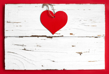 red heart on white wooden and red background with copy space. top view. love, valentines day