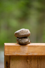 Two stones on top of each other on a wooden bridge