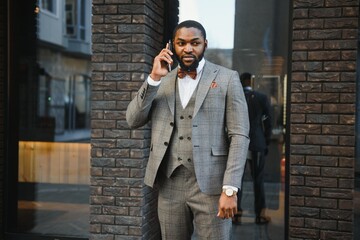 Portrait of an African American businessman wearing a suit standing in an outdoor business environment