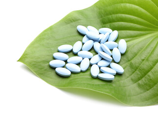 Plant based pills on white background