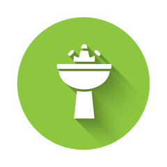 White Washbasin with water tap icon isolated with long shadow. Green circle button. Vector.