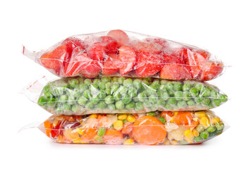 Frozen vegetables in plastic bags on white background