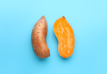 Fresh sweet potatoes on color background