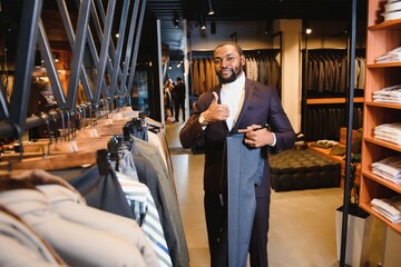 African American man, clothing store, chooses clothes