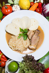 Baked pork chop with sauerkraut. Restaurant serving concept. Close-up.