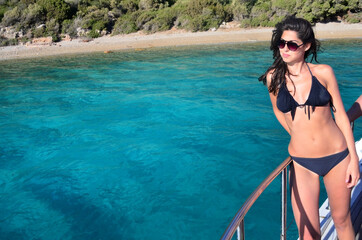 Obraz premium Beautiful Young Woman on a Sailing Boat in the Sea .Woman on Yacht 