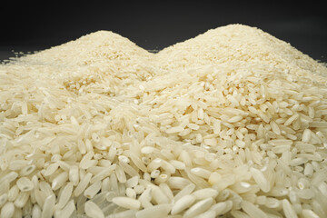 Uncooked dry rice grain on dark background macro
