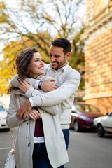 Happy young couple embracing laughing on date