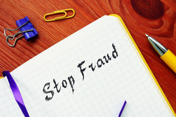 Financial concept about Stop Fraud  with inscription on the piece of paper.
