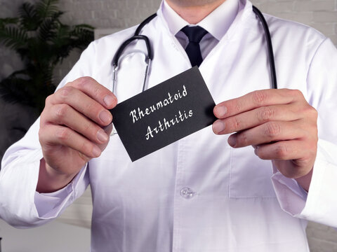 Medical concept meaning Rheumatoid Arthritis with phrase on the piece of paper.