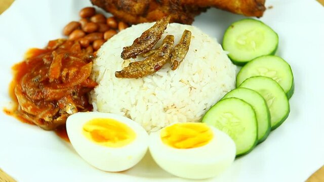 Nasi lemak (fragrant rice dish cooked in coconut milk and pandan leaf), Malaysian famous food.