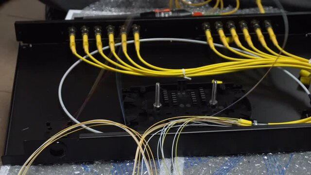 Expert technicians are connecting fiber optic cables into path