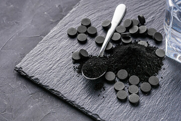 activated carbon on a dark stone background
