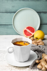 Cup of aromatic tea with lemon, ginger and honey on table