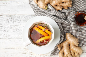 Cup of aromatic tea with lemon, ginger and honey on table