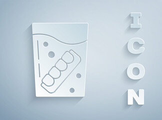 Paper cut False jaw in glass icon isolated on grey background. Dental jaw or dentures, false teeth with incisors. Paper art style. Vector.
