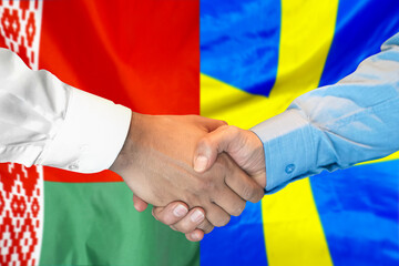 Business handshake on the background of two flags. Men handshake on the background of the Belarus and Sweden flag. Support concept