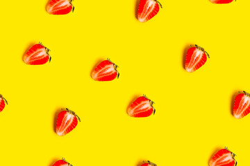 Abstract background with red fresh strawberryes on yellow background. Seamless pattern