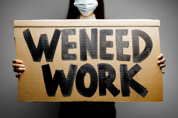 Ptotestive placards against job loss during coronavirus pandemic