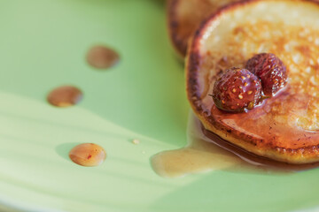 Homemade cottage cheese pancakes with strawberry jam. Traditional Russian cuisine.