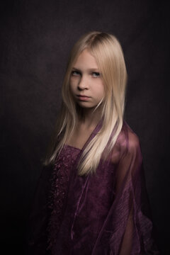 Classic studio portrait of a blonde girl in purple dress in painterly style