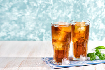 The glass of iced tea on wooden table. Cuba Libre or long island cocktail