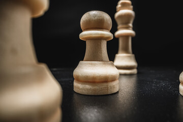 Chess game with chess pieces against black background