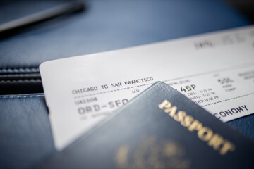 American passport and airplane ticket above a seat