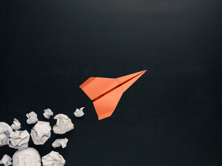 Launching paper rocket with jet stream of paper balls, creativity concept or new ideas metaphor,...