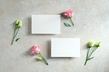Set of wedding invitation cards template design with flowers on stone table. Flat lay, top view.