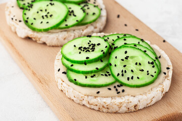 Rice cakes with nut butter and cucumbers with black sesame seeds