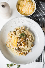 Risotto with porcini mushrooms and parmesan on a light background