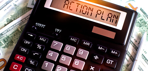 Calculator with text ACTION PLAN on the dollars. Business, finance conceptual.