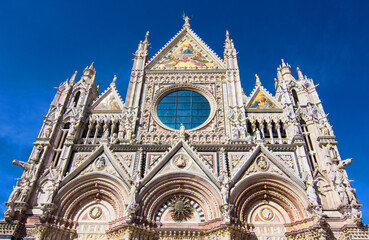Fototapeta na wymiar Siena Cathedral (Duomo di Siena) on Duomo square in Siena, Tuscany, Italy. It is a medieval church, now dedicated to the Assumption of the Blessed Virgin Mary, completed between 1215 and 1263